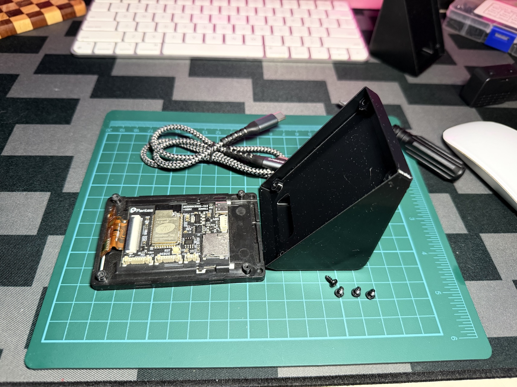 The board placed screen-down next to the open side of the stand